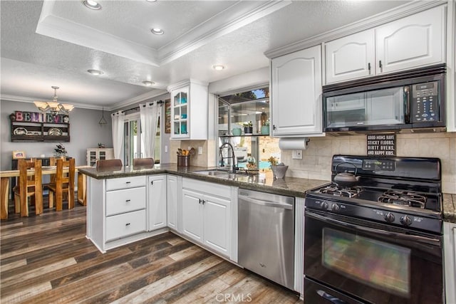 kitchen with white cabinets, kitchen peninsula, sink, and black appliances