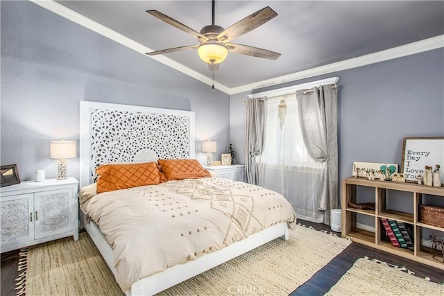 bedroom with lofted ceiling, hardwood / wood-style floors, ornamental molding, and ceiling fan