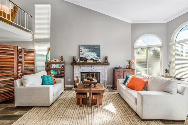 living room with hardwood / wood-style flooring, a fireplace, and ornamental molding