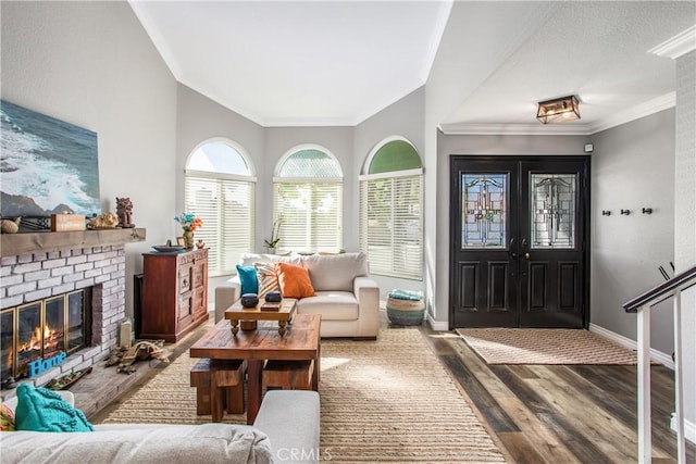 interior space featuring ornamental molding, a brick fireplace, and hardwood / wood-style floors