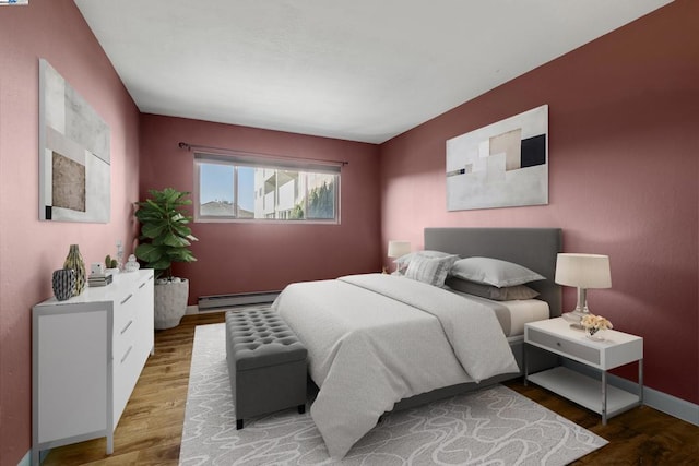 bedroom with hardwood / wood-style flooring and a baseboard radiator