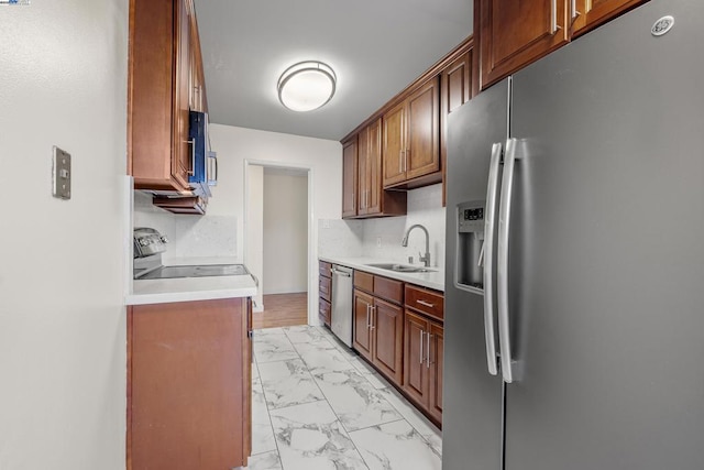 kitchen with sink, decorative backsplash, and appliances with stainless steel finishes