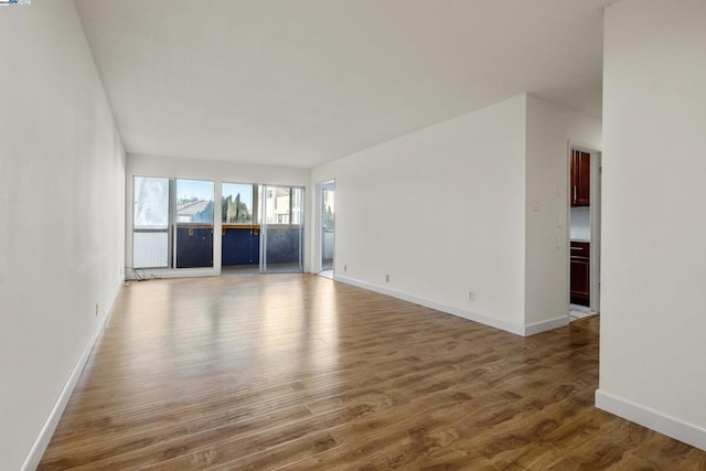 unfurnished living room featuring wood-type flooring