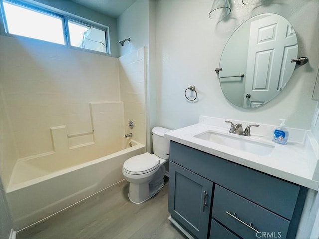 full bathroom featuring wood-type flooring, vanity, washtub / shower combination, and toilet