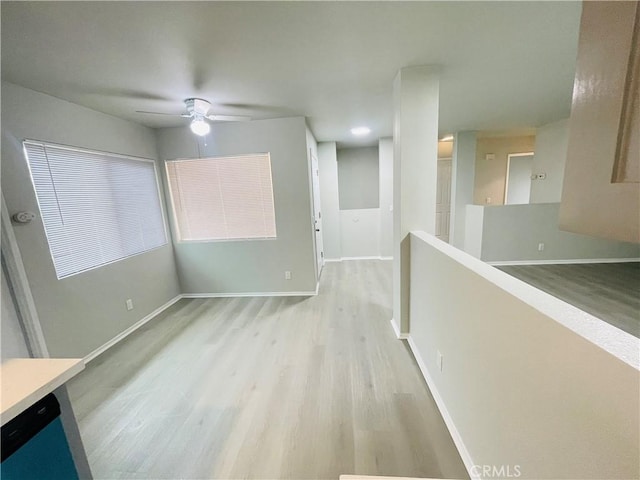 interior space with ceiling fan and light hardwood / wood-style floors