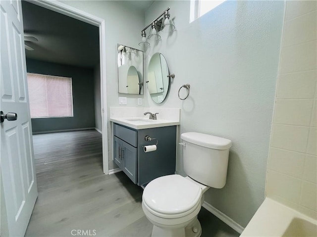 bathroom with vanity, toilet, and hardwood / wood-style floors