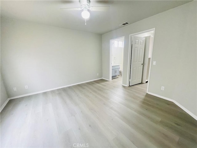 spare room with ceiling fan and light hardwood / wood-style flooring