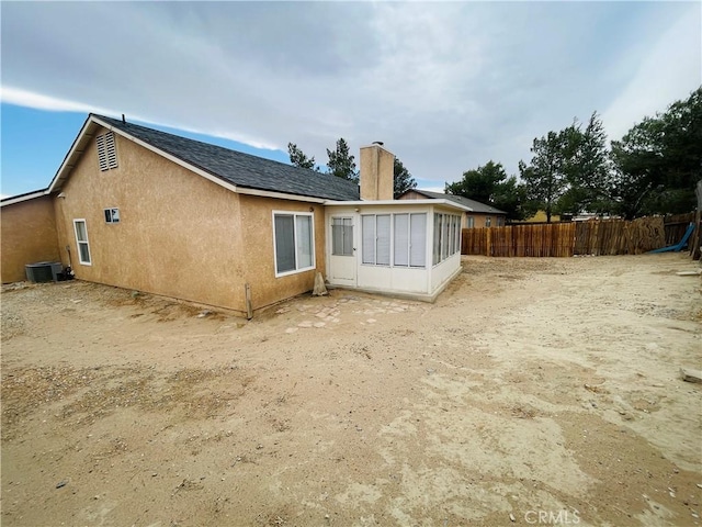 back of house with a sunroom and central air condition unit