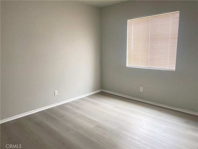 empty room with light hardwood / wood-style flooring