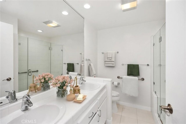 bathroom with vanity, tile patterned floors, toilet, and walk in shower