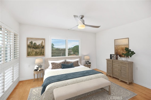 bedroom with ceiling fan and light wood-type flooring