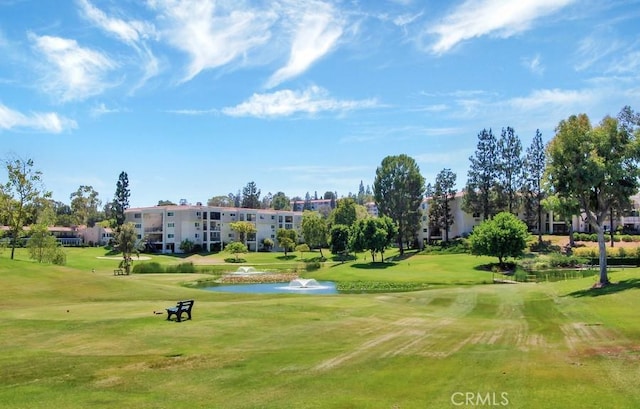 view of community featuring a water view and a lawn