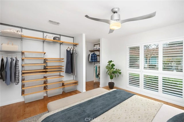 bedroom featuring hardwood / wood-style floors, ceiling fan, and a closet