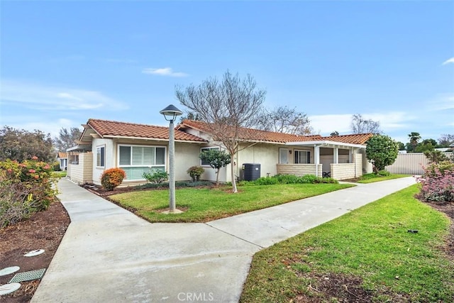 view of front of property featuring a front yard and central air condition unit