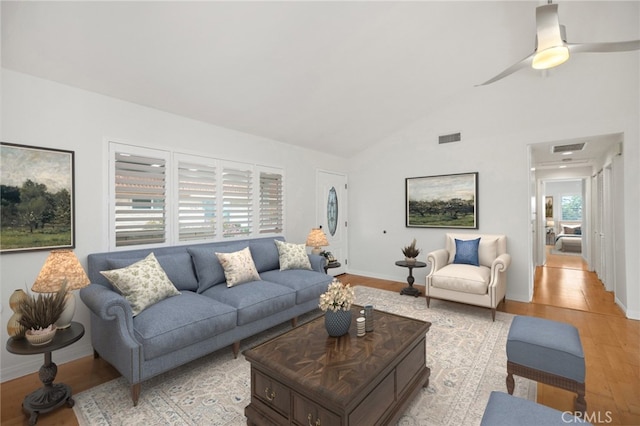 living room featuring vaulted ceiling and light hardwood / wood-style floors