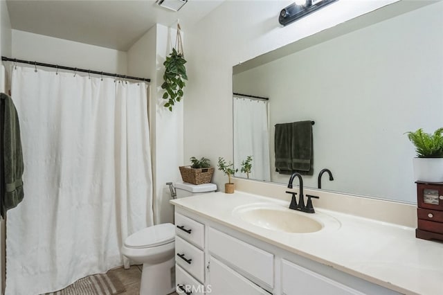 full bathroom with toilet, vanity, and tile patterned floors