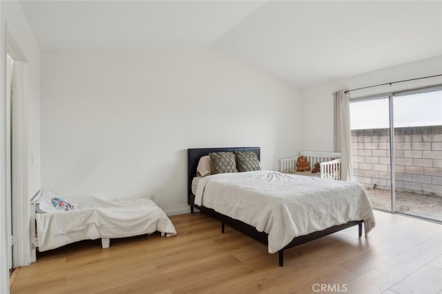 2979 Cardamon St, Rialto, CA 92376 - bedroom featuring access to outside, light wood-style flooring, and vaulted ceiling