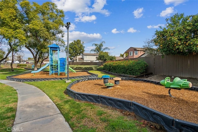community play area with fence and a yard