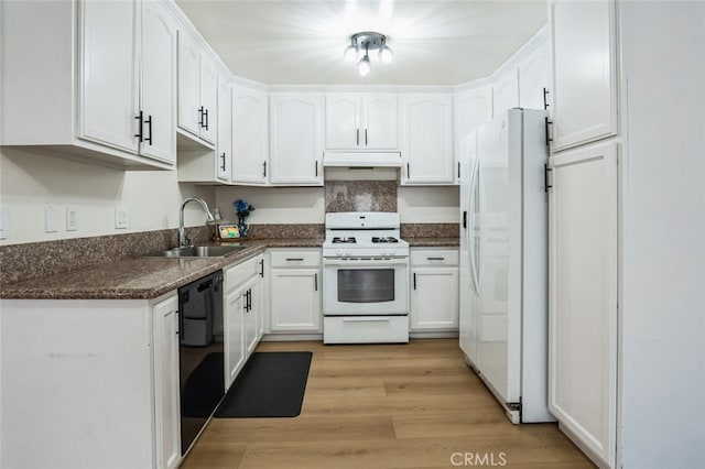 kitchen with under cabinet range hood, white appliances, a sink, white cabinets, and dark countertops