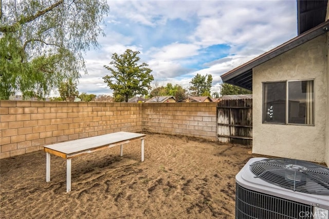 view of yard featuring central air condition unit and a fenced backyard