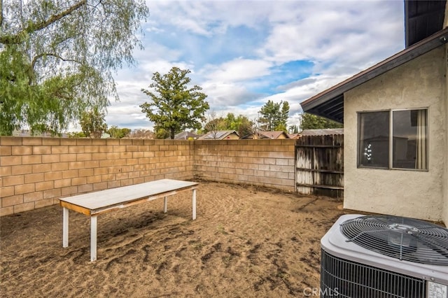 view of yard featuring central AC and a fenced backyard