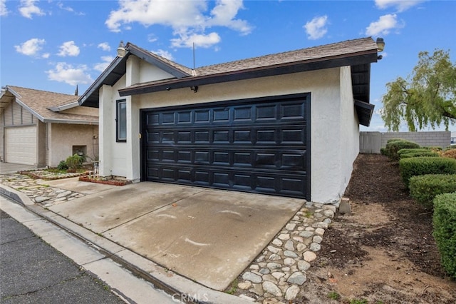 2979 Cardamon St, Rialto, CA 92376 - view of front of home featuring stucco siding, a garage, driveway, and fence