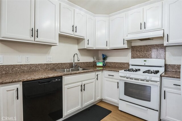 kitchen featuring black dishwasher, white gas range, under cabinet range hood, white cabinetry, and a sink