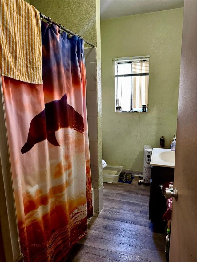 full bathroom with shower / bath combination with curtain, vanity, toilet, and hardwood / wood-style floors