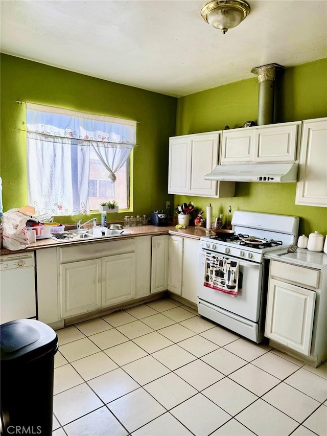 kitchen featuring white cabinetry, white appliances, sink, and light tile patterned floors