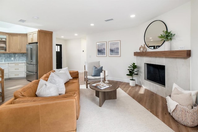 living room with a fireplace and light hardwood / wood-style floors