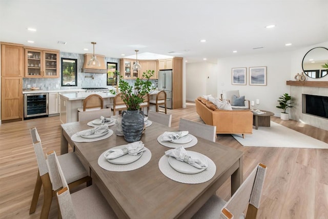 dining area featuring light hardwood / wood-style floors and beverage cooler