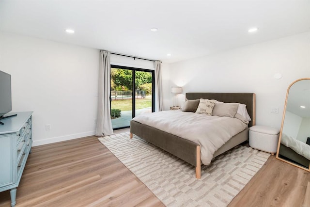 bedroom with access to outside and light wood-type flooring