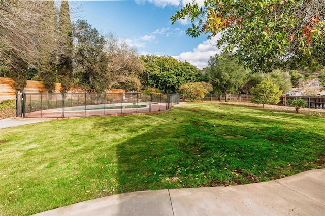 view of yard with a fenced in pool