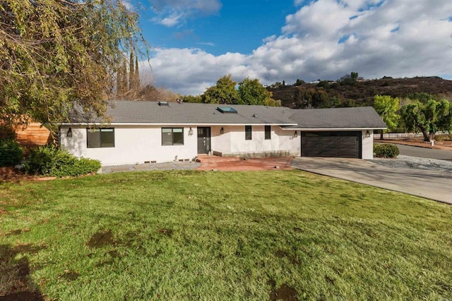 ranch-style house with a garage and a front yard