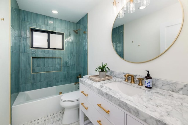 full bathroom featuring tiled shower / bath, vanity, toilet, and tile patterned floors