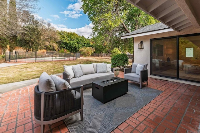 view of patio featuring an outdoor living space with a fire pit