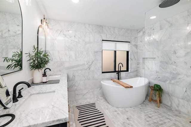 bathroom featuring vanity, shower with separate bathtub, and tile walls