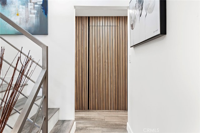 stairs featuring hardwood / wood-style flooring