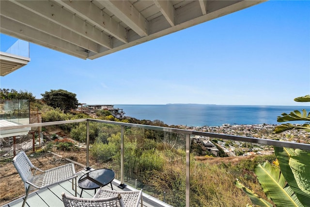 balcony featuring a water view