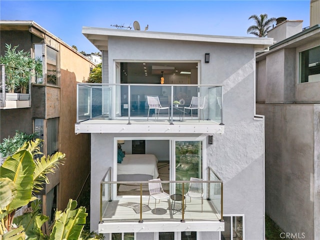 back of house with a balcony