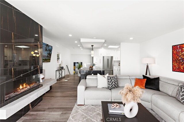 living room with hardwood / wood-style flooring and a fireplace