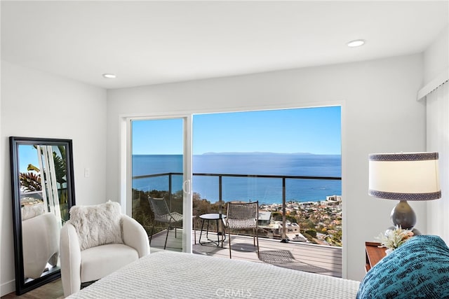 bedroom with multiple windows and a water view