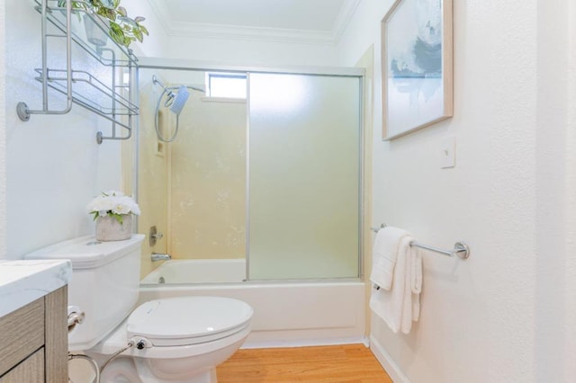 full bathroom featuring enclosed tub / shower combo, ornamental molding, toilet, and vanity