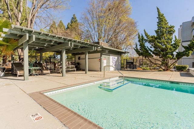 view of pool with a pergola and a patio area