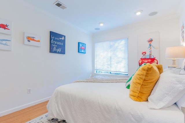 bedroom featuring crown molding and hardwood / wood-style floors