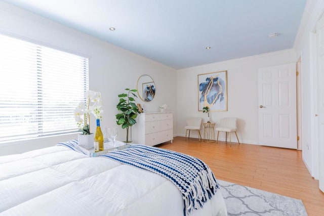 bedroom featuring ornamental molding and hardwood / wood-style floors