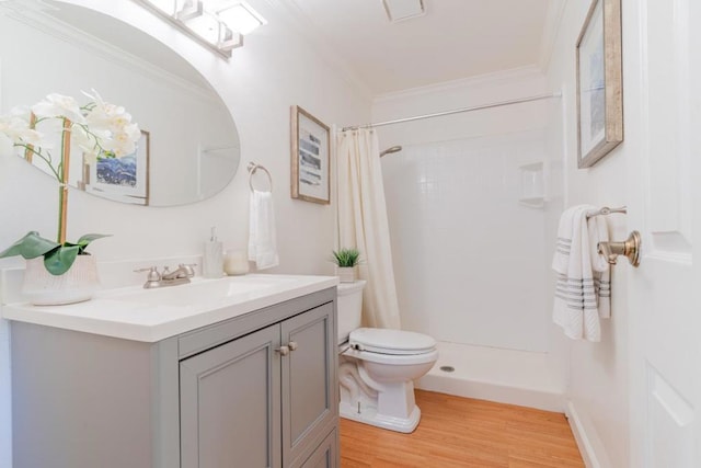 bathroom with crown molding, hardwood / wood-style floors, curtained shower, and vanity