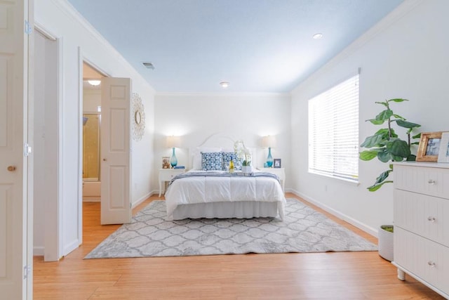 bedroom featuring ornamental molding and light wood-type flooring