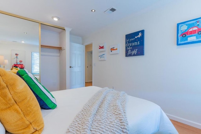 bedroom featuring hardwood / wood-style flooring and a closet