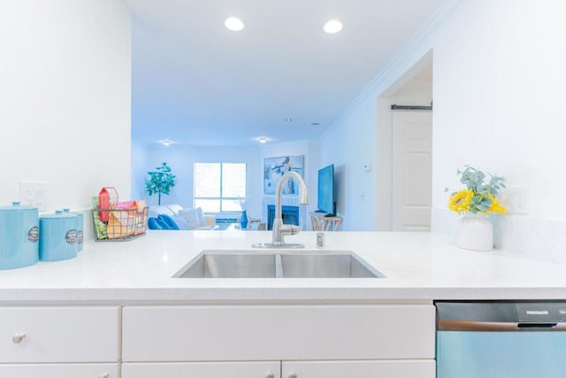 kitchen featuring sink, ornamental molding, white cabinets, and dishwasher